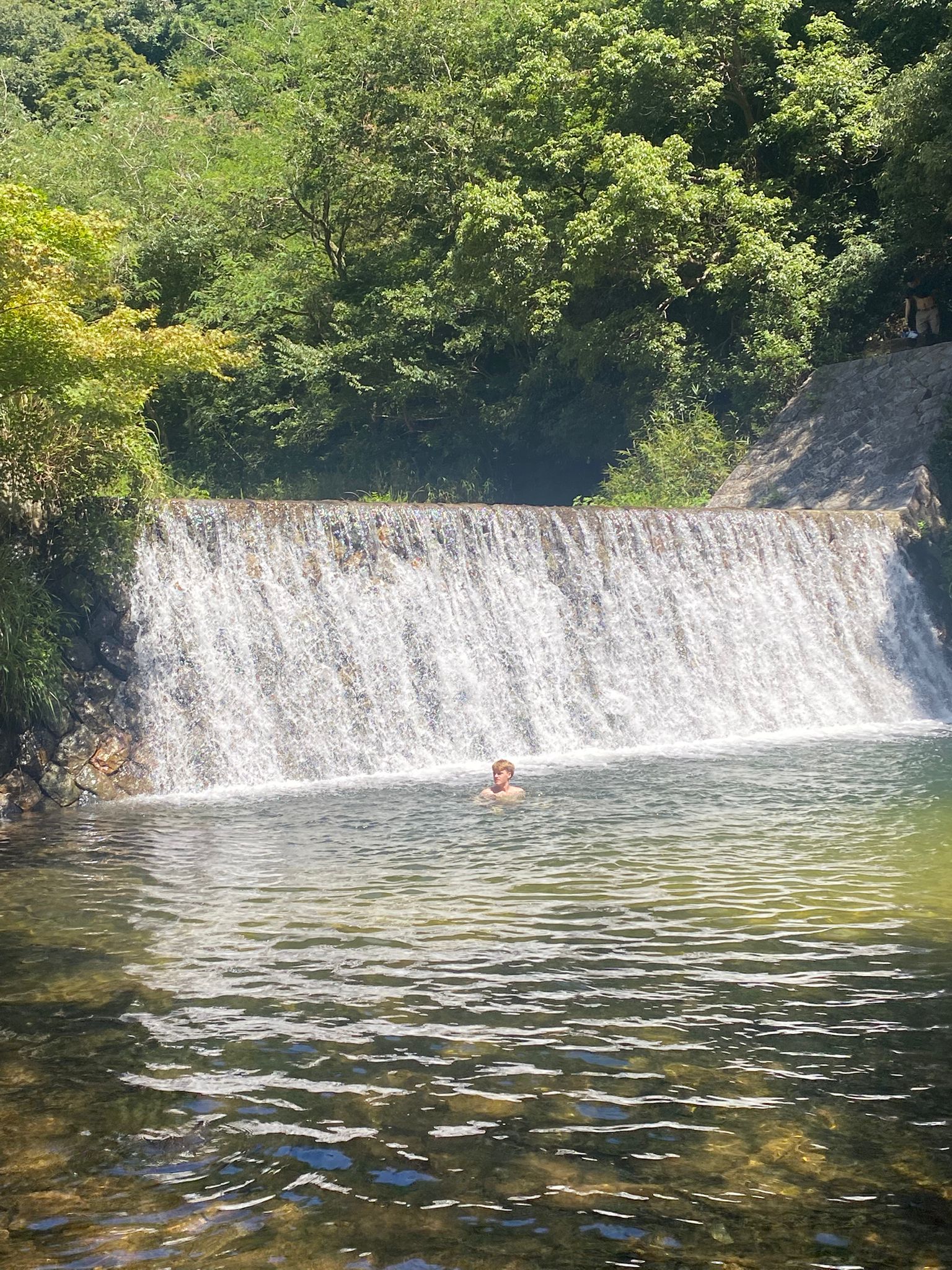 Swimming at a waterfall during a hike